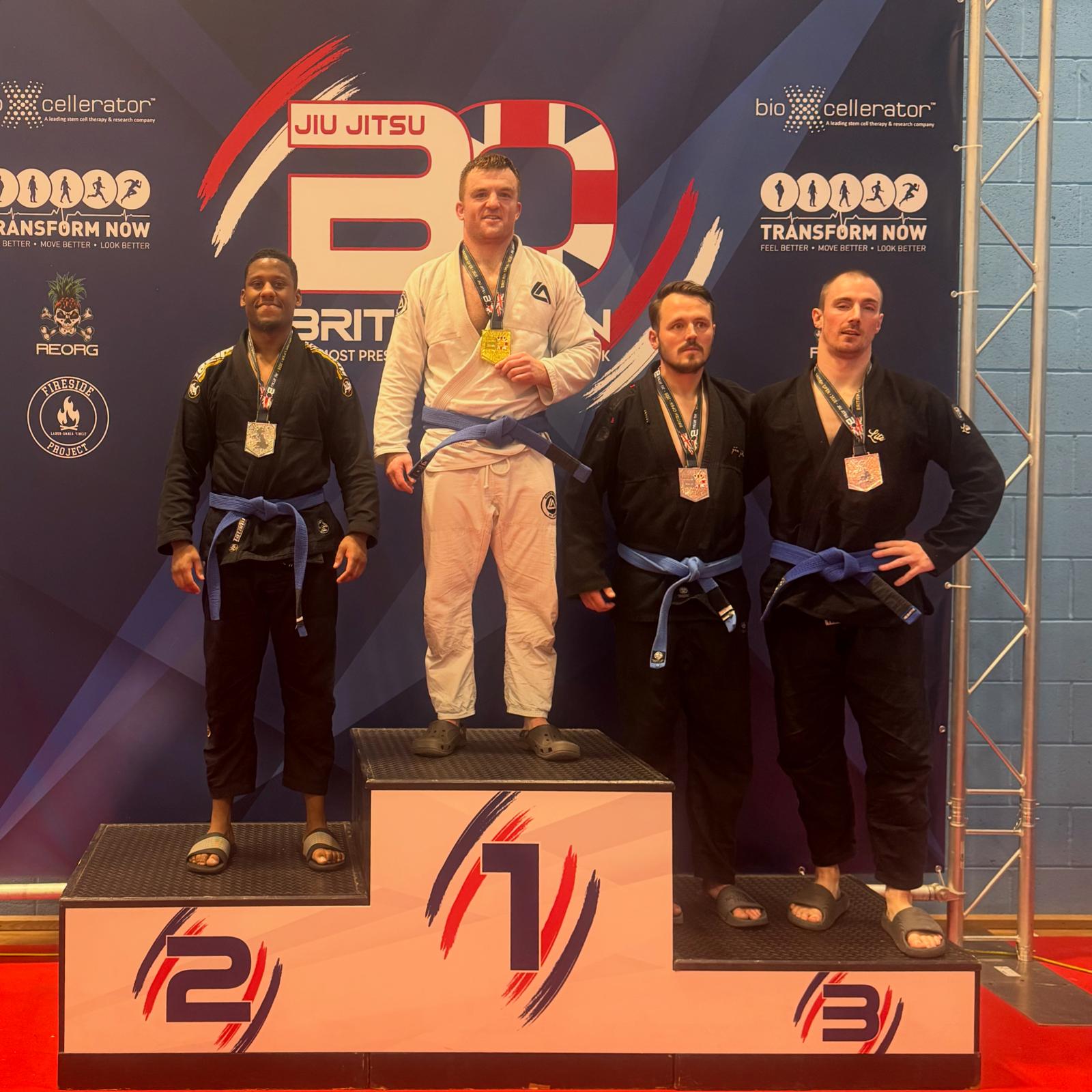 Kane Howden on the podium with a medal at a Jiu Jitsu British Open competition